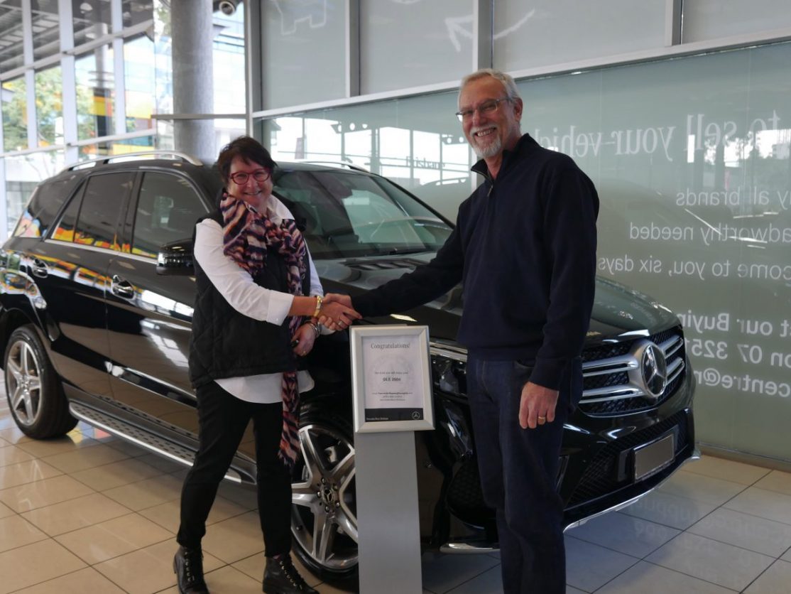 Winner Kylie with CEO collecting her new car