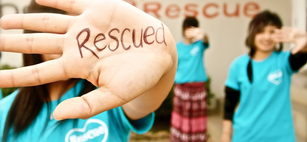 Children With the Word Rescued Written on Their Palms