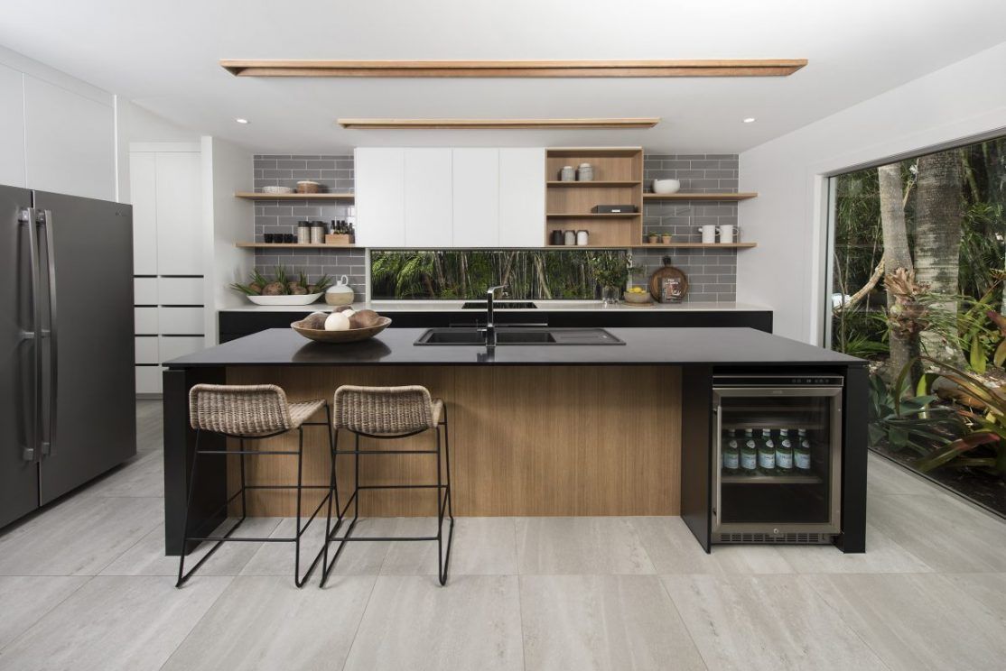 Modern kitchen with appliances, pantry and wine fridge.