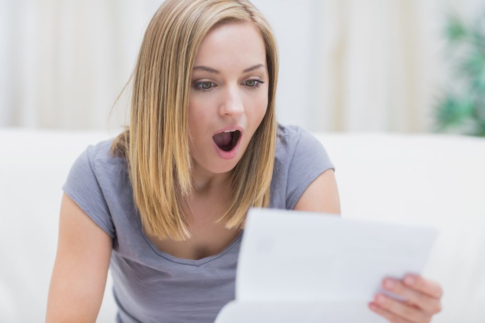 Photodune 8450304 Shocked Young Woman Reading Letter in Living Room at Home S