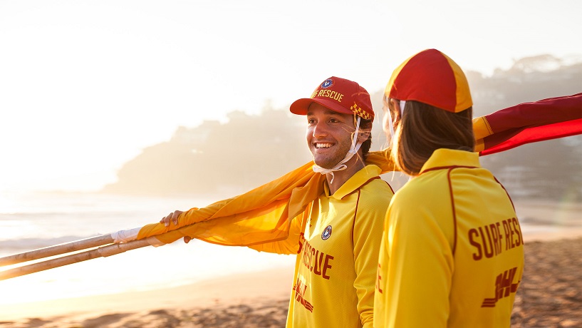 Two Surf Life Savers on the beach.