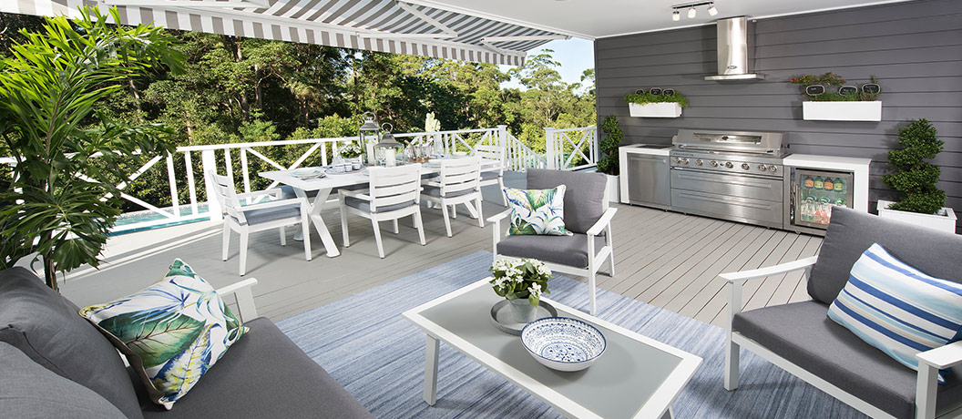 Alfresco outdoor dining area with BBQ and pool view